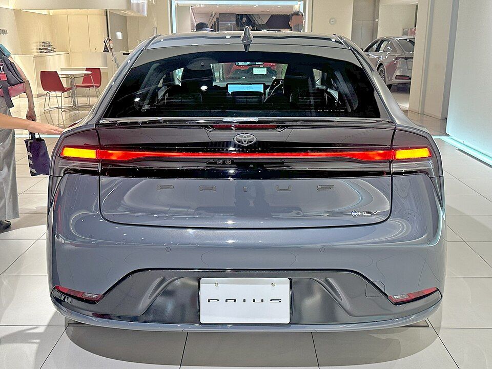From behind: a full-width light bar and the Prius name across the tailgate.